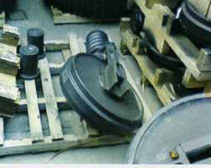 IDLERS, DESIGNED TO BE INSTALLED AT THE FRONT OF A CRUSHING MACHINE TRACK FRAME TO GUIDE THE TRACK LINK ASSEMBLY.  MADE FROM CAST STEEL THE IDLERS ARE SPECIFICALLY SHAPED AND DESIGNED TO FIT A PARTICULAR MODEL OF CRUSHING MACHINE.