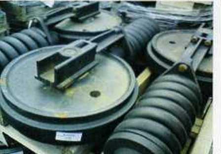 IDLERS, DESIGNED TO BE INSTALLED AT THE FRONT OF A CRUSHING MACHINE TRACK FRAME TO GUIDE THE TRACK LINK ASSEMBLY.  MADE FROM CAST STEEL THE IDLERS ARE SPECIFICALLY SHAPED AND DESIGNED TO FIT A PARTICULAR MODEL OF CRUSHING MACHINE.