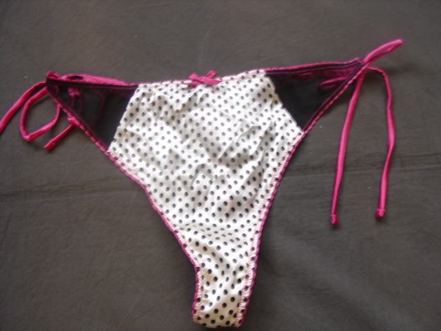 A PAIR OF WOVEN AND KNITTED THONG STYLE HIPSTER BRIEFS WHERE THE WOVEN FABRIC PREDOMINATES. ELASTICATED AT TOP OF GARMENT AND AROUND LEGS. BACK OF GARMENT MADE OF ELASTIC MESH WITH A WOVEN FRONT PANEL.. WITH TIE FASTENINGS AT THE SIDE. WITH LINED GUSSETT. 66 PER CENT SILK, 24 PER CENT POLYAMIDE AND 10 PER CENT ELASTANE. PRESENTED WITH AN UPPER UNDERWIRED GARMENT WHICH HAS BEEN CLASSIFIED SEPARATELY UNDER 117674949.