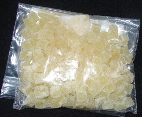 DEHYDRATED AND PREPARED PINEAPPLE PIECES (APPROX 1 X 1 CM)  WITH ADDED SUGAR PACKAGED IN 20 KILO  CORRUGATED CARTONS.