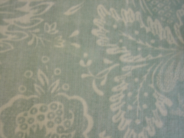 WOVEN FABRIC. WITH PRINTED SURFACE FORMING FLORAL LEAF SHAPED PATTERN. OF A WIDTH 144CM WEIGHING 420G PER METRE SQ. FABRIC IS MADE FROM 100 PERCENT LINEN.