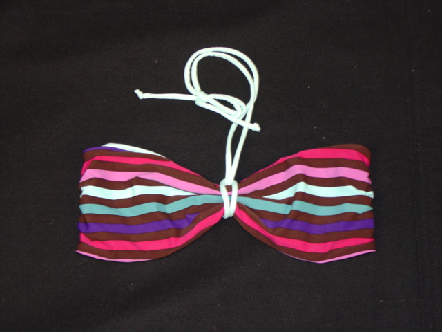 WOMENS KNITTED BANDEAU STYLE BRASSIERE. WITH REMOVABLE HALTER STRAP WHICH TIES THROUGH THE MIDDLE TO GIVE SHAPE. WITH REINFORCED SIDE SEAMS. WITH OPENING AT BACK.WITH PLASTIC CLIP FASTENING.OF 90 PERCENT NYLON AND 10 PERCENT ELASTANE.