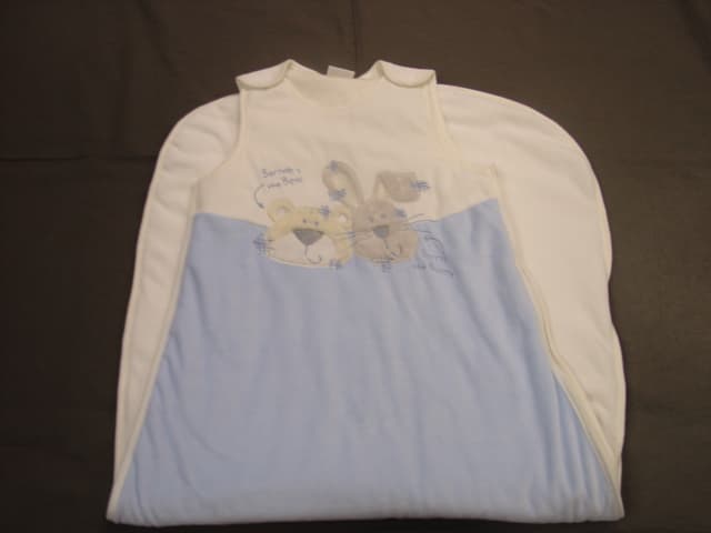 A  KNITTED, VELOUR, PADDED GARMENT FOR SLEEPING IN. REACHING DOWN FROM THE SHOULDERS TO THE FEET, ENCASING THE WHOLE OF THE BODY APART FROM THE ARMS. DESIGNED FOR CHILD 18 TO 36 MONTHS OF AGE. GARMENT MEASURES 110 CM IN LENGTH. WITH A COMPLETE OPENING DOWN THE LEFT HAND SIDE FASTENING WITH A ZIP. WITH PRESS-STUDS ON EACH SHOULDER. WITH AN EMBROIDERED BUNNY DESIGN ON THE FRONT. 80 PERCENT COTTON. 20 PERCENT POLYESTER.