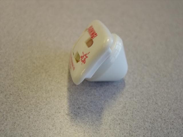 SECURITY INK TAG WITH CONE LOCK MECHANISM.THIS DEVICE IS DESIGNED TO BE ATTACHED TO CLOTHING IN A RETAIL ENVIRONMENT.THE INK TAG IS MADE FROM HARD PLASTIC AND CONTAINS INDELIBLE INKS, WHICH CAN BE SEEN THROUGH CLEAR PANELS ON ONE SIDE.A STEEL PIN PROJECTS FROM THE INK TAG ON THE OTHER SIDE.THE CONE LOCK CONSISTS OF A MOULDED HARD PLASTIC OUTER COVERING THAT CONTAINS BALL LEVERS WHICH GRASP AND LOCK ONTO THE PIN ON THE INK TAG. IF THE DEVICE IS TAMPERED WITH THE INK IS RELEASED STAINING BOTH THE GARMENT AND THE PERSON TAMPERING WITH IT. THE CONE LOCK IS CORRECTLY DETACHED AT THE SALES COUNTER BY HOLDING IT AGAINST A STRONG SPECIALLY SHAPED MAGNET.IN THIS CASE THE INK TAG AND CONE LOCK ARE ATTACHED TO EACH OTHER. INK TAG MEASURES 4CM BY 2.6CM AND CONE MEASURES 2.5CM IN DIAMETER  BY 1.8CM DEEP.