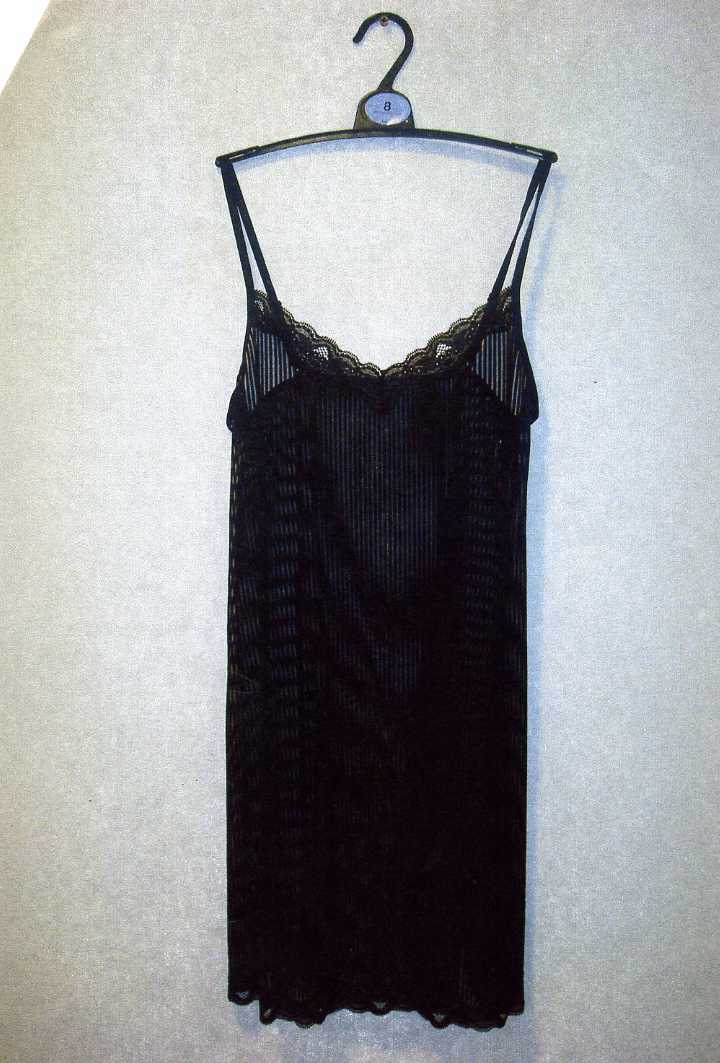 A KNITTED BLACK SLIP. DESIGNED TO COVER THE BODY FROM THE SHOULDERS TO BELOW THE WAIST. WITH THIN ADJUSTABLE SHOULDER STRAPS. WITH V-NECKLINE. HEMMED. THE GARMENT IS MADE FROM 89 PER CENT POLYESTER AND 11 PER CENT ELASTANE. PRESENTED ON A PLASTIC HANGER WHICH HAS BEEN CLASSIFIED SEPARATELY.
