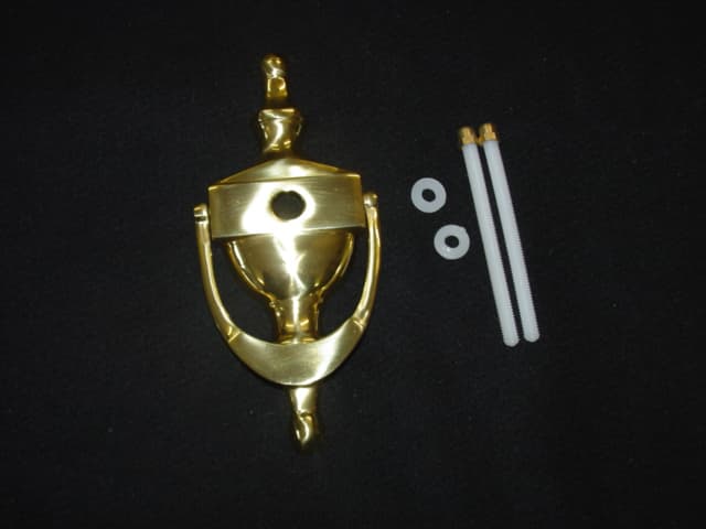DOOR KNOCKER MADE FROM COATED BRASS. THE  COMPOSITION OF THE BRASS IS 60 PERCENT COPPER AND 40 PERCENT ZINC. SUPPLIED WITH TWO NUTS AND THREADED RODS FOR FIXING. THEY ARE USED IN DOMESTIC HOUSING APARTMENTS AND BUILDINGS. PACKAGED IN A CARDBOARD BOX.