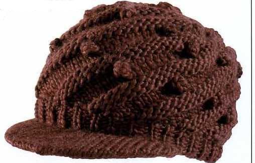 KNITTED PEAKED CAP.  OF ACRYLIC. WITH KNITTED  BOBBLE DECORATION.  PACKED ON CARD WITH PLASTIC SWING TICKET AND HANGER.