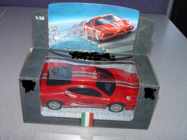 TOY PLASTIC MODEL CAR WITH A TWO SPEED GEAR BOX. WHEN THE CAR IS PULLED BACK FULLY IT TRAVELS FORWARD. SOUND CHIP GIVES OFF ENGINE REVVING NOISES. BUTTON ON UNDERSIDE OF CAR - WHEN DEPRESSED CAR STEERS LEFT, THEN RIGHT THEN STRAIGHTENS UP DURING FORWARD MOTION. SIX DESIGNS - ALL 1:38 SCALE MODELS OF FERRARI CARS. PACKED IN BUSTER PACKAGING WITH BACKING CARD.