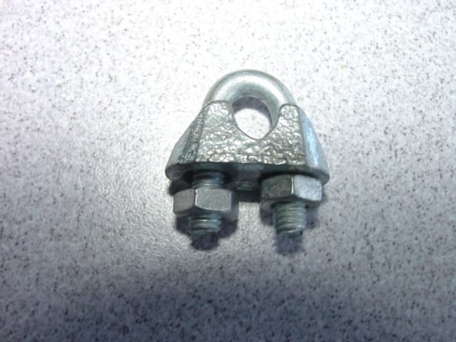 A COMMERCIAL WIRE ROPE GRIP WITH A BRIDGE MADE FROM MALLEABLE CAST IRON, WHICH IS THE MAJOR CONSTITUENT PART OF THIS PRODUCT. THE U BOLT AND NUTS ARE MADE FROM MILD STEEL WITH A GALVANISED FINISH. WIRE ROPE GRIPS ARE USED ON WIRE ROPE TO MAKE COMPLETE LOOPS, END TO END CONNECTION OR TEMPORARY JOINTS WHERE SPLICING IS NOT POSSIBLE.