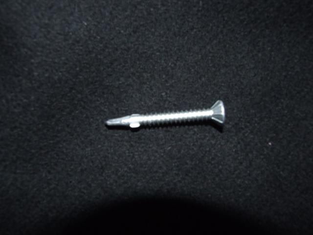 A SELF-DRILLING SCREW WITH A BIFURCATED POINT MADE OF STEEL . DESIGNED FOR ATTACHING FIXTURES TO STEEL. THE SCREW IS ATTACHED TO A DRILL AND SCREWED THROUGH THE FIXTURE AND INTO THE STEEL. USED FOR FIXING METAL CLADDING, ATTACHING FRAME CRAMPS ETC.  PACKAGED FOR RETAIL SALE IN BOXES OF A HUNDRED. DIAMETER AND  SHANK THICKNESS LESS THAN 6MM