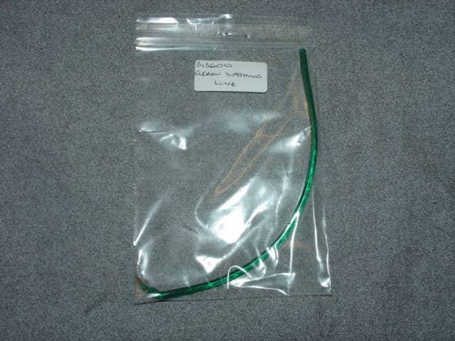PLASTIC WASHING LINE WITH A BRASS COATED STEEL CORE. DIAMETER MEASURES APPROXIMATELY 3 MM.