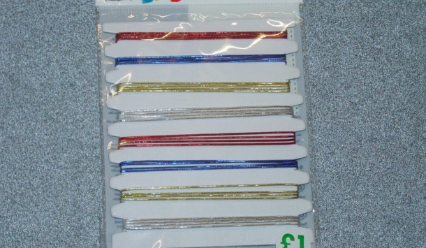 COLOURED THREAD SILVER, GOLD, BLUE AND RED TO BE USED FOR ART AND CRAFT CREATIONS. THE STRING CONSISTS OF RUBBER THREAD COVERED IN POLYETHYLENE STRIP WHICH IS LESS THAN 5MM IN WIDTH. INCLUDES PLASTIC CONNECTORS. PACKAGED ON A CARD IN PLASTIC BAG FOR RETAIL SALE.