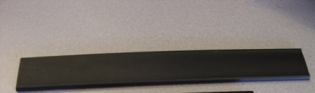 A PROFILE SHAPE OF POLYETHYLENE MEASURING 4 CM IN WIDE WITH ROUNDED EDGES AND A CONSISTANT CROSS-SECTION, FROM ONE END TO THE OTHER.  USED TO CONNECT CONTINUOUS LENGTHS OF UNIAXIAL GEOGRIDS IN THE PRINCIPLE STRENGTH DIRECTION.  USED IN CIVIL ENGINEERING APPLICATIONS.