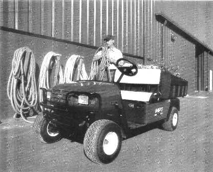 AN ELECTRICALLY POWERED, HEAVY DUTY, UTILITY VEHICLE.  FRAME: WELDED STEEL WITH POWDER COAT FINISH.  FRONT BODY AND FINISH: INJECTION MOULDED.  STANDARD COLOUR: FOREST GREEN.  POWER SOURCE: 48 VOLTS DC MOTOR.  HORSEPOWER: 2.5 HP AT 2700 RPM.  SEATING CAPACITY: 2 PERSONS.  DRY WEIGHT (WITHOUT BATTERIES): 367 KG.  OVERALL LENGTH: 2807 MM.  OVERALL WIDTH: 1265 MM.  OVERALL HEIGHT: 1727 MM (WITH CANOPY), 1234 MM (TO TOP OF STEERING WHEEL).  WHEEL BASE: 1956.