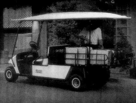 AN ELECTRIC VEHICLE FOR TRANSPORTING CARGO.  FRAME: WELDED STEEL WITH POWDER COAT FINISH.  FRONT BODY AND FINISH: INJECTION MOULDED WITH BASE COAT / CLEAR COAT.  REAR BODY AND FINISH: STEEL, BASE COAT / CLEAR COAT.  STANDARD COLOUR: CHAMPAGNE.  POWER SOURCE: 48 VOLT DC MOTOR.  HORSEPOWER: 18.1 HP AT 1900 RPM.  SEATING CAPACITY: 2 PERSONS.  DRY WEIGHT (WITHOUT BATTERIES): 322 KG.  OVERALL LENGTH: 3505 MM.  OVERALL WIDTH: 1181 MM.  OVERALL HEIGHT: 1880 MM (WITH CANOPY), 1234 (TO TOP OF STEERING WHEEL).  WHEEL BASE: 2375 MM.