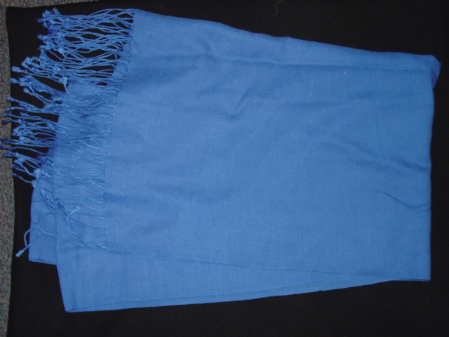 A WOVEN SCARF MADE FROM 53 PERCENT VISCOSE AND 47 PERCENT WOOL. HEMMED WITH FRINGES AT EACH END. MEASURES 56CM WIDE 184CM LONG. BLUE IN COLOUR.