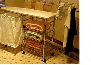 A PAINTED FOLD AWAY IRONING BOARD MEASURING APPROX 110.49CMS X 49CMS WITH SPECIALLY DESIGNED COTTON CLOTH COVER WITH PADDING TO REDUCE MOVEMENT WHEN IRONING. THREE SLIDE OUT CHROME WIRE BASKETS FOR EASY STORING OF FRESHLY IRONED GARMENTS, A SLIDE OUT LAUNDRY HAMPER FOR HOLDING WASHING READY TO IRON, A FOLD OUT IRON REST AND ADJUSTABLE CLOTHES RACK. THE ESSENTIAL CHARACTER OF THIS PRODUCT IS GIVEN BY THE IRONING BOARD.