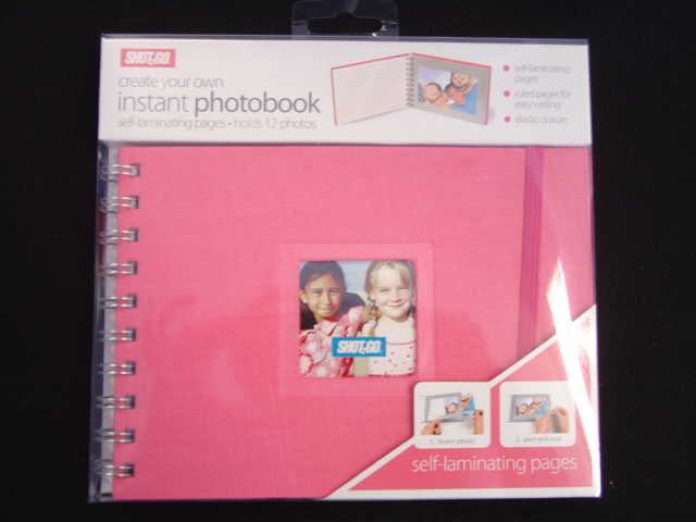 PHOTO ALBUM MEASURING 180 MM IN LENGTH BY 130 MM DEPTH.  SPIRAL BOUND.  PAPERBOARD COVER WITH TEXTILE COVERING.  THE FRONT COVER HAS A SMALL CLEAR PLASTIC CUT OUT TO PUT A PERSONAL PHOTO IN.  THE ALBUM HOLDS 12 PHOTOS WITH A PAPER BACK AND PLASTIC SEAL. THE LEFT HAND SIDE OF THE ALBUM HAS RULED PAGES FOR EASY WRITING. ELASTIC CLOSURE. PACKAGED IN CLEAR PLASTIC PACKAGING WITH CARDBOARD INSERT.