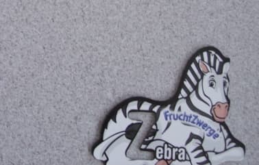 FRIDGE MAGENT. IN THE SHAPE OF A ZEBRA. OF PRINTED LAMINATED PAPER. WITH A PERMANENT MAGNET OF AGGLOMERATED FERRITE. WITH THE FIRST LETTER OF THE ANIMALS NAME CUT OUT TO ACT AS A STENCIL. 1 OF 26 DESIGNS. PACKAGED AS A SET OF 2.