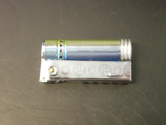 POCKET LIGHTER. PETROL FUELLED IN TUBULAR CYLINDER. WITH FLINT IGNITION, WICK AND WADDING. WITH RETRACTABLE CASING ALLOWING SPRING LOADED FLINT TO BE REPLACED. CYLINDER ALLOWS FOR REFUELLING THRUGH ABSORBENT WADDING. SIZE: 60MM LONG X 30MM WIDE.CONSIGNED OTHER THAN FROM TAIWAN.