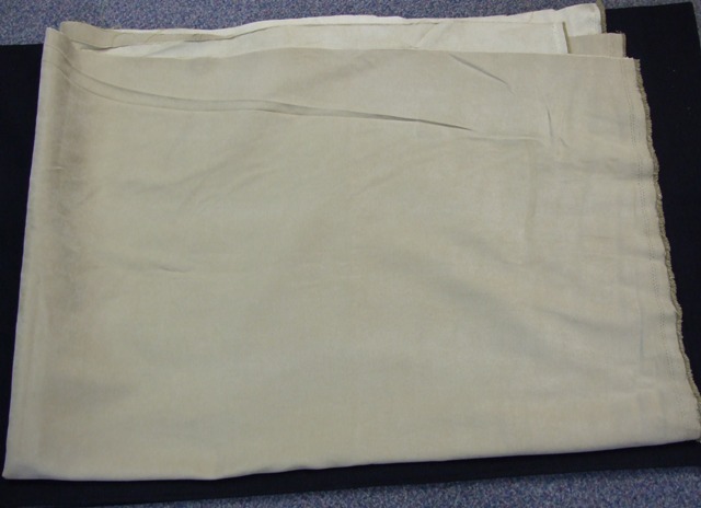 A WOVEN FABRIC MADE FROM FILAMENT NON TEXTURED YARNS OF 100% POLYESTER DYED AND BRUSHED TO GIVE SUEDE AFFECT BEIGE IN COLOUR.