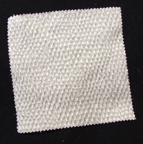 A JACQUARD WOVEN FABRIC MADE FROM 72 PER CENT SILK AND 28 PER CENT ACRYLIC. WEIGHING 168 G/M2 AND 134CM WIDTH FINISHED. CONSTRUCTED FROM YARNS OF DIFFERENT COLOURS. BEIGE IN COLOUR
