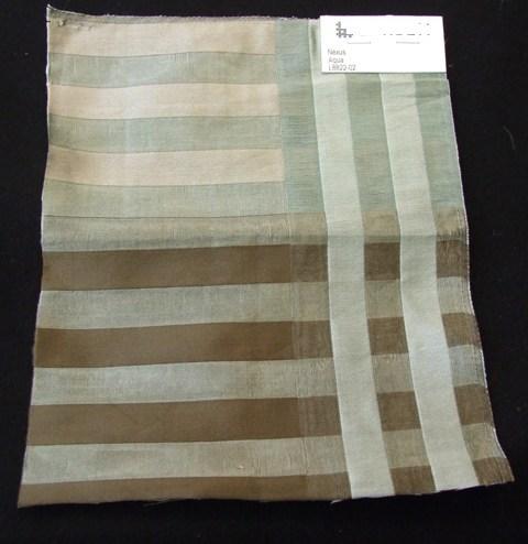 A JACQUARD WOVEN FABRIC MADE FROM 78 PER CENT SILK AND 22 PER CENT LINEN. WEIGHING 123 G/M2 AND 140CM WIDTH FINISHED. CONSTRUCTED FROM YARNS OF DIFFERENT COLOURS. BEIGE, GREEN, BROWN STRIPES.