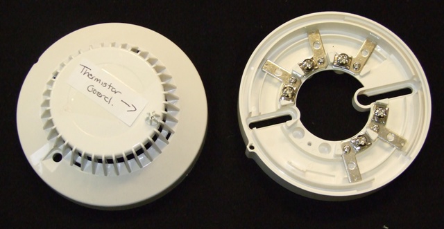 THE THERMISTOR GUARD AND HOLDER ARE SPECIFICALLY SHAPED AND DESIGNED PLASTIC MOULDINGS THAT ARE USED TO HOLD AND PROTECT THE THERMISTOR WITHIN THE HEAT DETECTOR.