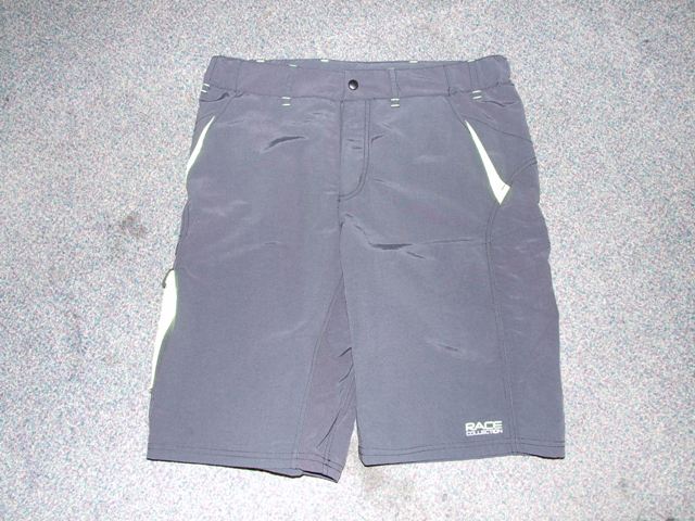 WOVEN SHORTS FOR MEN.  DESIGNED TO COVER THE LOWER PART OF THE BODY BETWEEN THE WAIST AND KNEE.  PARTIAL OPENING TO FRONT WITH  A PROTECTIVE FLAP THAT GOES LEFT OVER RIGHT, ZIP FASTENER AND LEFT OVER RIGHT PRESS STUD FASTENING. WITH ELASTICATION AT WAIST. WITH BELT LOOPS. LEGS ARE HEMMED. WITH SIDE POCKETS. WITH TWO BACK POCKETS ON BACK OF SHORTS, ONE WITH ZIP FASTENING AND THE OTHER WITH VELCRO.WITH LOGO. OF NYLON.