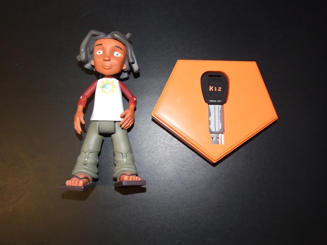 USB PRE RECORDED FLASH MEMORY STICK (512MB) PACKAGED WITH A PLASTIC TOY HUMAN CHARACTER, CLASSIFIED SEPARATELY. THE KEY IS PLUGGED INTO A COMPUTER WHICH IS CONNECTED TO THE INTERNET AND ALLOWS ACCESS TO THE COMPANY WEBSITE WHERE CHILDREN CAN INTERACT WITH OTHER CHILDREN AND PLAY COMPUTER GAMES. THE TWO ITEMS ARE PACKAGED TOGETHER IN A CARDBOARD BOX WITH ACETATE WINDOW.