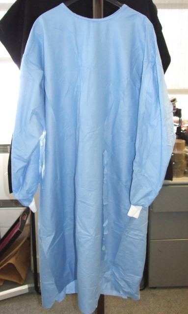 PATIENT GOWN FOR USE IN HOSPITALS. DESIGNED TO COVER THE BODY FROM THE SHOULDERS TO JUST BELOW THE KNEE. WITH A COMPLETE OPENING AT THE BACK WITH VELCRO FASTENING AT THE NECK AND TIE FASTENING AT THE WAIST. WITH LONG SLEEVES WITH ELASTICATED CUFFS.  MADE FROM 55 PER CENT CELLOLOSE FIBRES (PAPER) AND 45 PER CENT POLYESTER FIBRES. FLUID REPELANT. DISPOSABLE AFTER USE.