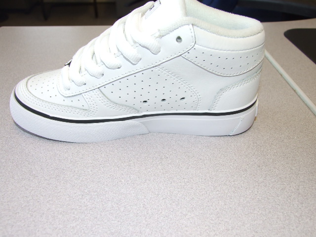 A CHILDS LACE UP SKATEBOARDING SHOE. WITH LEATHER UPPERS AND RUBBER OUTER SOLES. COVERING THE ANKLE BUT NO PART OF THE CALF. WITH TECHNICAL FEATURE IN THE FORM OF A SHOCK ABSORBING CUSHIONING PAD DESIGNED TO ABSORB IMPACT. TREAD PATTERN DESIGNED FOR IMPROVED SKATEBOARD GRIP. INSOLE LENGTH LESS THAN 24CMS. CIF PRICE ABOVE 7.5 EURO. WITH LOGO ON UPPERS, HEEL, TONGUE AND OUTER SOLE. SHOES SOLD IN PACKAGING MENTIONING COMPANYS COMMITMENT TO SKATEBOARDING.