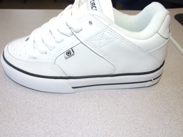 A CHILDS LACE UP SKATEBOARDING SHOE. WITH LEATHER UPPERS AND RUBBER OUTER SOLES. NOT COVERING THE ANKLE. WITH TECHNICAL FEATURE IN THE FORM OF A SHOCK ABSORBING CUSHIONING PAD DESIGNED TO ABSORB IMPACT. TREAD PATTERN DESIGNED FOR IMPROVED SKATEBOARD GRIP. INSOLE LENGTH LESS THAN 24CMS. CIF PRICE ABOVE 7.5 EURO. WITH LOGO ON UPPERS, HEEL, TONGUE AND OUTER SOLE. SHOES SOLD IN PACKAGING MENTIONING COMPANYS COMMITMENT TO SKATEBOARDING.