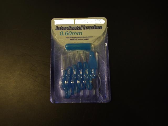 INTERDENTAL BRUSHES SPECIALLY DESIGNED TO CLEAN AROUND BRACES, BRIDGES AND IN THE GAPS BETWEEN TEETH. BRUSH IS MADE OF METAL WIRE AND MAN-MADE FILAMENTS FITTED INTO A PLASTIC HANDLE. THE METAL WIRE IS PLASTIC COATED TO ALLOW USE AROUND METAL FILLINGS. WITH A HYGIENIC CAP FOR PROTECTING THE BRUSH BETWEEN USES AND WHILST TRAVELLING. LENGTH OF BRUSH 15MM, LENGTH OF HANDLE 33MM, OVERALL LENGTH 48MM. PACKAGED FOR RETAIL IN A BLISTER PACK OF 6 INTERDENTAL BRUSHES AND ONE PROTECTIVE CAP.