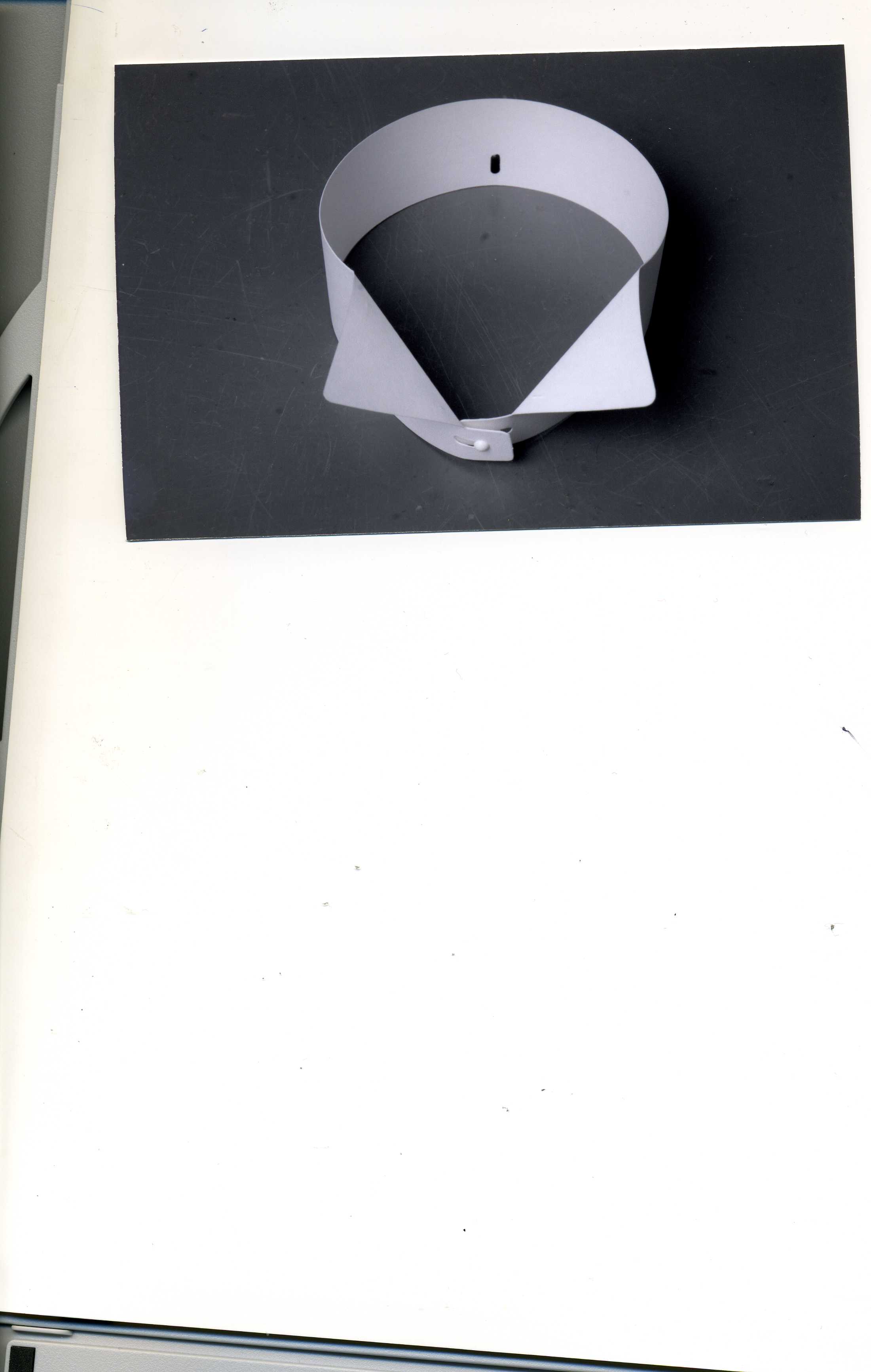 A WHITE COLLAR MADE OF A PAPER. THE ITEM IS USED BY MEN AND WOMEN WITH A COLLARLESS SHIRT FOR FORMAL OCCASIONS. THEY ARE ATTACHED TO SHIRTS BY SEPARATE FIXINGS (FIXINGS ARE SEPARATE TO THE COLLAR AND SHIRT).