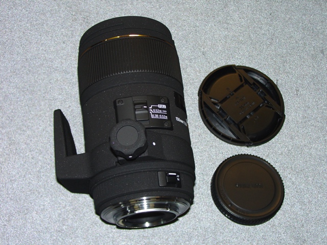 AN OBJECTIVE LENS FOR A PHOTOGRAPHIC CAMERA. OF GLASS, METAL AND PLASTIC. WITH A  FIXED FOCAL LENGTH OF 150MM AND A FRONT DIAMETER OF 72MM AND OVERALL DIAMETER OF 79.6MM. WITH REMOVABLE PLASTIC LENS CAPS. LENS LENGTH 137 MM. WEIGHT 895G.