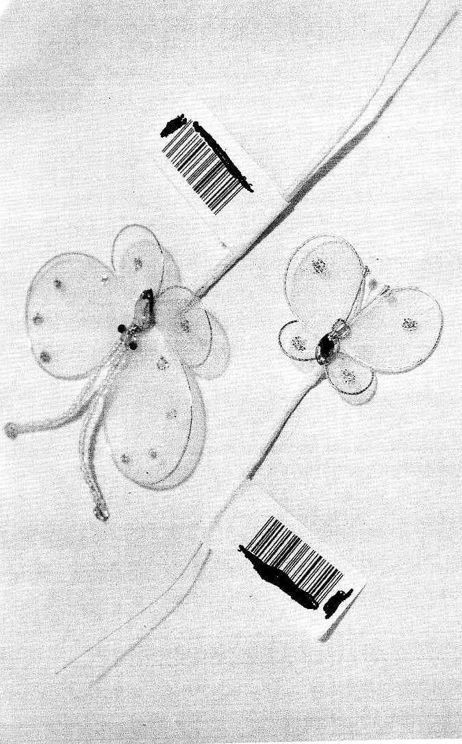 ORNAMENTAL ARTICLE. BUTTERFLY PICK. INCORPORATES A LONG STEEL WIRE STEM WITH STEEL WIRE BUTTERFLY SHAPES  ATTACHED TO THE STEMS WHICH ARE COVERED IN TEXTILE. DECORATED WITH PLASTIC STONES.DESIGNED FOR USE IN BOUQUETS, TABLE DECORATIONS, TIARAS AND CHRISTMAS DECORATIONS. MEASURES APPROX 30CMS (L).