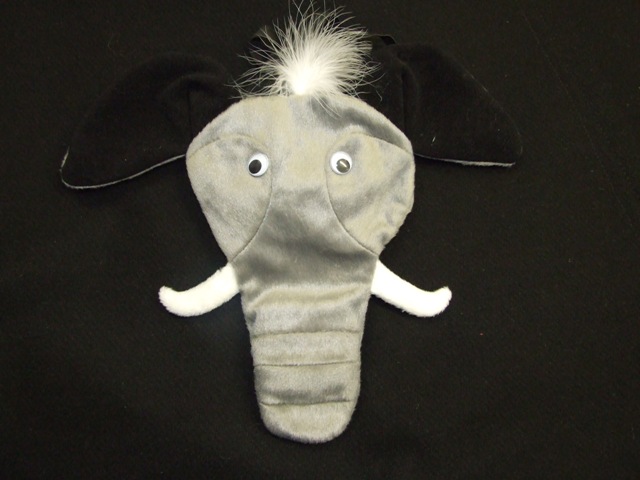 NOVELTY GARMENT CONSTRUCTED OF WOVEN POLYESTER AND ACRYLIC. DESIGNED TO BE WORN AS A POSING POUCH. IN THE SHAPE OF AN ELEPHANTS HEAD, WITH EARS, TRUNK AND EYES. NARROW BANDS OF ELASTIC HOLD THE POUCH IN PLACE AROUND THE WAIST AND BETWEEN THE LEGS.  THE TRUNK CONTAINS A SOUND CHIP WHICH MAKES AN ELEPHANT SOUND WHEN PRESSED.