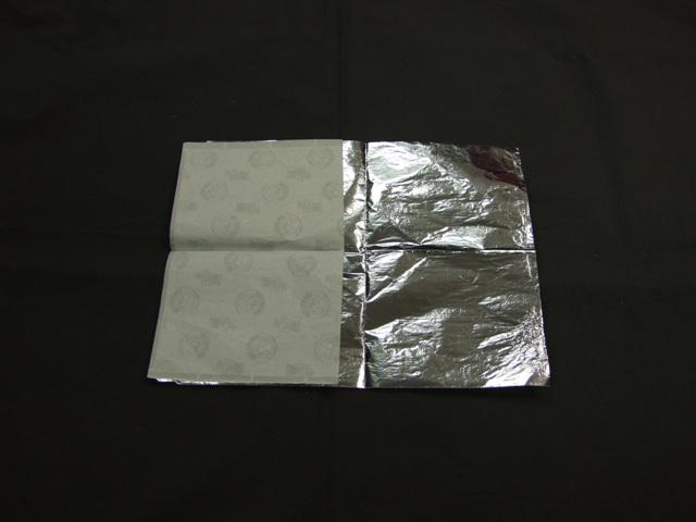 ALUMINIUM FOIL WRAP (USED FOR HOT DOGS) BACKED WITH PAPER IN RECTANGULAR SHEETS. THICKNESS 0.00025MM EXCLUDING BACKING.