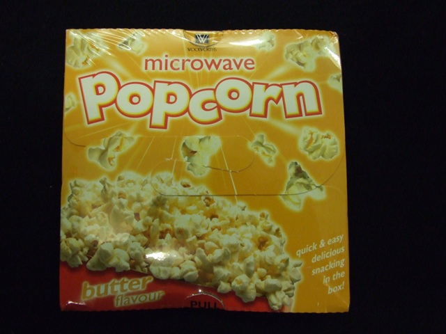 BUTTER FLAVOUR MICROWAVE POPCORN.
PACKAGED IN A CARDBOARD CONTAINER, WRAPPED IN CELLOPHANE.
