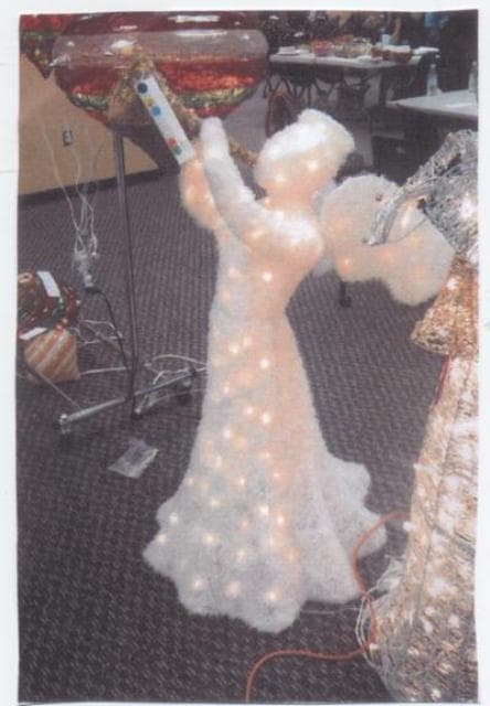 LIGHT-UP ANGEL. FLOOR STANDING. 48 INCHES TALL. CLEAR FILAMENT LIGHTS ON AN IRON WIRE FRAMEWORK. LIGHT FITMENTS MADE OF PLASTIC.