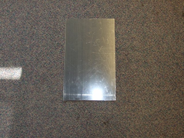 ACRYLIC POLYMER POLYMETHYL METHACRYLATE MIRROR IN SHEET FORM GREY IN COLUR WITH A REMOVABLE PLASTIC PROTECTIVE FILM. APPROXIMATE MEASUREMENTS 310MM X 189MM