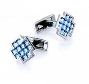 A PAIR OF CUFFLINKS. OF STAINLESS STEEL WITH 12 LIGHT BLUE FACETED GLASS CRYSTALS. CROSS SHAPED. PACKAGED FOR RETAIL SALE IN A PLASTIC AND PAPER GIFT BOX.