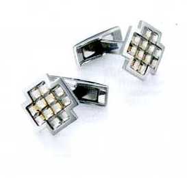 A PAIR OF CUFFLINKS. OF STAINLESS STEEL WITH 12 GOLDEN SHADOW FACETED GLASS CRYSTALS. CROSS SHAPED. PACKAGED FOR RETAIL SALE IN A PLASTIC AND PAPER GIFT BOX.