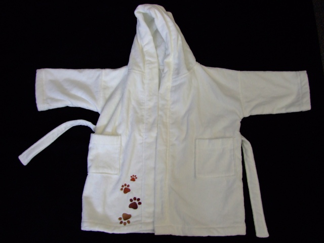 100% ORGANIC COTTON. BABIES DRESSING GOWN. DESIGNED FOR BABIES AGED 12-24 MONTHS. WITH COMPLETE OPENING WITH BELT STITCHED TO GARMENT. WITH HOOD. WITH SLEEVES. WITH A POCKET ON EITHER SIDE.