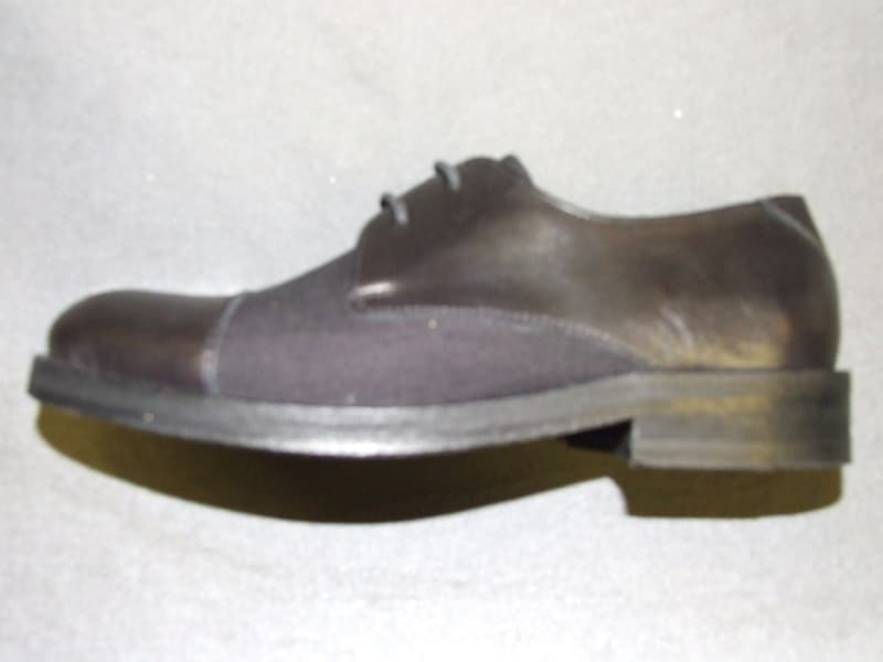 LADIES LEATHER AND TEXTILE UPPER SHOE. THE LEATHER PREDOMINATES.  LACE UP. WITH VIABLE LEATHER UPPER TOE CAP. WITH TEXTILE TONGUE AND TAPERED SHOE SIDES. WITH LEATHER HEEL TO FOREFOOT REACHING THE EYELETS.  WITH LEATHER SOLE WITH SMALL RUBBER HALF HEEL GRIP.