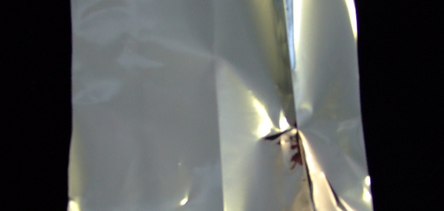 A POLYESTER BASED BARRIER EZ PEEL NON-FORMING FILM. IT IS CONSTRUCTED WITH AN OUTER LACQUER, INK, METALLISED OPET, ADHESIVE, EZ PEEL SEALANT. MATERIAL COMPOSED OF A LAYER OF GAUGE METALIZED POLYETHYLENE TEREPHTHALATE (PET) WITH ADHESIVE TO A LAYER OF 2.0 MIL POLYETHYLENE FILM. FINISHED THICKNESS OF FILM 2.5 MIL( 0.0635 MM). IT IS USED IN MEDICAL PACKAGING FOR APPLICATIONS REQUIRING MODERATE LIGHT, OXYGEN AND MOISTURE BARRIER. THE METALLIZATION PROVIDES INTERMEDIATE OXYGEN AND MOISTURE BARRIER, WHILST THE EZ PEEL SEALANT PROVIDES CONSISTENT PEEL FORCE AND  VISUAL TRANSFER.SPECIFIC GRAVITY 1.080.IN ROLLS