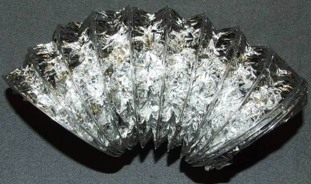 ALUMINIUM FOIL DUCTING. THE PRODUCT IS A FLEXIBLE AND COMPRESSIBLE TUBE CONSISTING OF ALUMINIUM FOIL SUPPORTED ON A SPIRAL STEEL WIRE.  APPROXIMATE DIAMETER OF THE DUCTING IS 105MM.