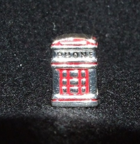 STERLING SILVER CHARM  IN THE FORM OF A TELEPHONE BOX WITH ENAMEL INSERTS. THE CHARM IS DESIGNED TO BE THREADED ONTO A FLEXIBLE BRACELET ALONG WITH OTHER SIMILAR BEADS OR CHARMS IN COLOURS OR DESIGNS OF THE WEARERS CHOICE. DIMENSIONS 10MM BY 5MM BY 5MM.