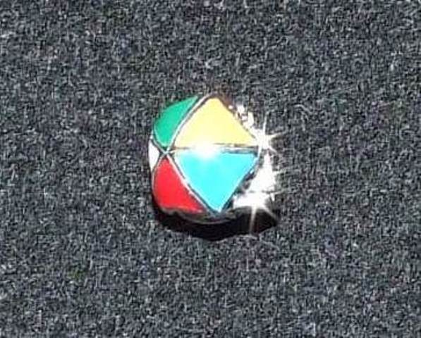 A STERLING SILVER CHARM . THE CHARM IS ENMELLED AND HAS A BEACH THEME.IT IS DESIGNED TO BE THREADED ONTO A FLEXIBLE BRACELET ALONG WITH OTHER SIMILAR BEADS OR CHARMS IN COLOURS OR DESIGNS OF THE WEARERS CHOICE. DIMENSIONS APPROXIMATELY 10MM IN DIAMETER.
